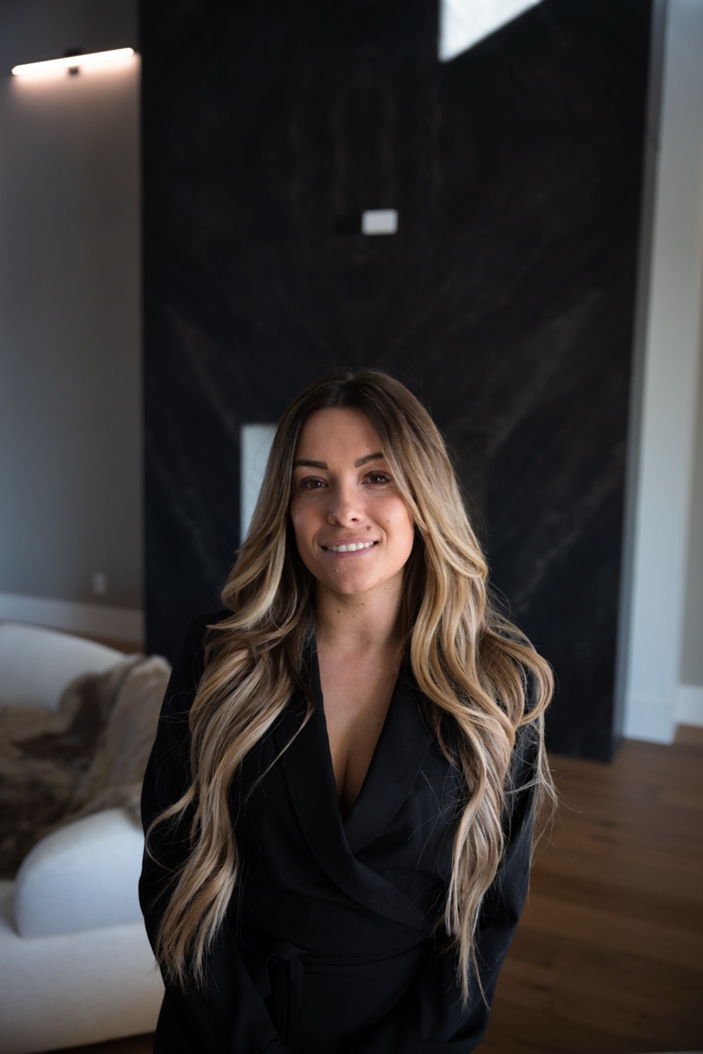 Hannah McKernan, founder of Solstizio Studios, standing in a styled living room